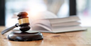 Judge gavel with book in background