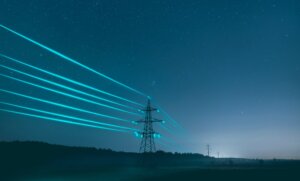 Telephone pole with blue light around the wires