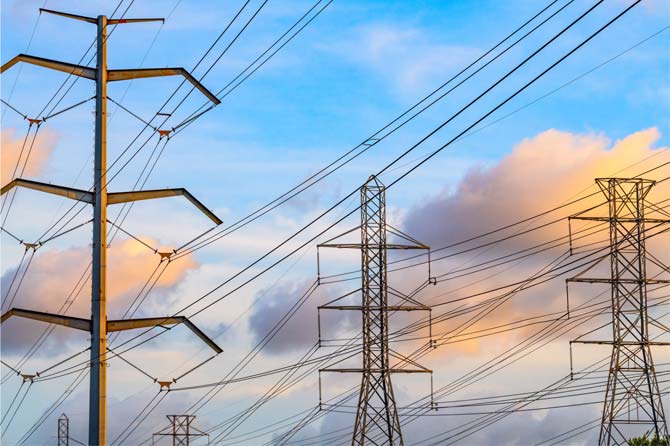 Picture of electrical lines with clouds in background