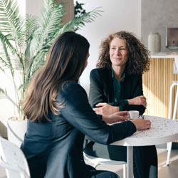Two women having coffee together at a table