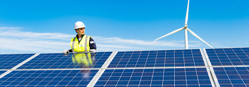 Operator inspecting solar panel out in the field